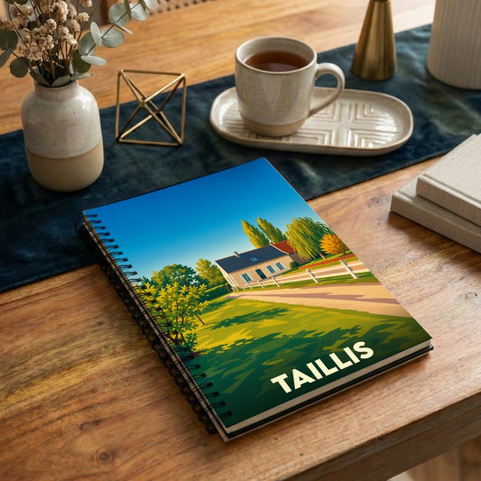 Carnet à spirales souvenir de la ville de Taillis avec une illustration stylisée de paysage.