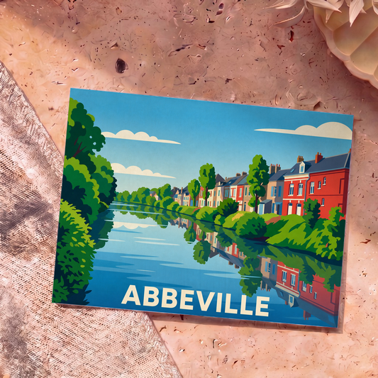 Carte postale souvenir de la ville d'Abbeville avec une illustration stylisée de maisons colorées bordant la Somme.