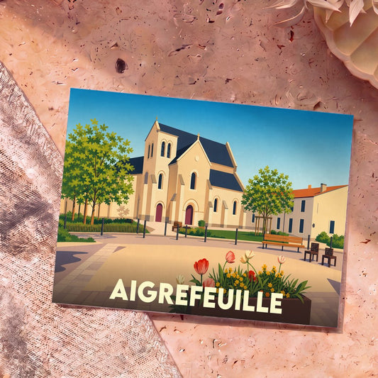 Carte postale souvenir de la ville d'Aigrefeuille avec une illustration stylisée de son église et d'une place fleurie.