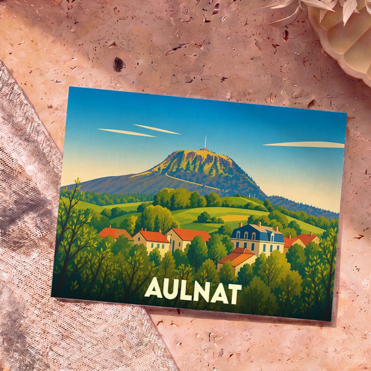 Carte postale souvenir de la ville d'Aulnat avec une illustration stylisée d'un village au pied d'un volcan.