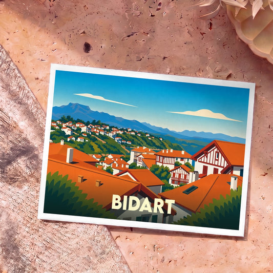 Carte postale souvenir de Bidart avec une illustration stylisée montrant les toits rouges du village face aux montagnes des Pyrénées.