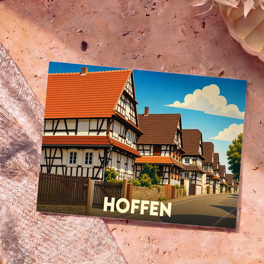 Carte postale souvenir de la ville de Hoffen avec une illustration stylisée de maisons à colombages traditionnelles.