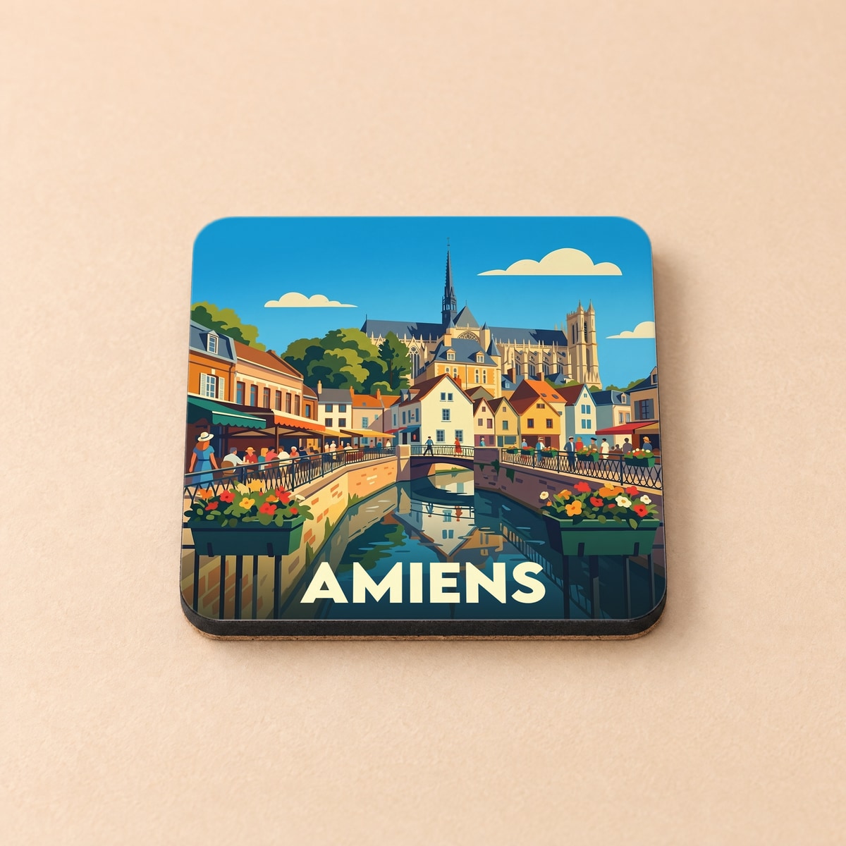 Dessous de verre souvenir de la ville d'Amiens avec une illustration stylisée de ses canaux et de sa cathédrale.