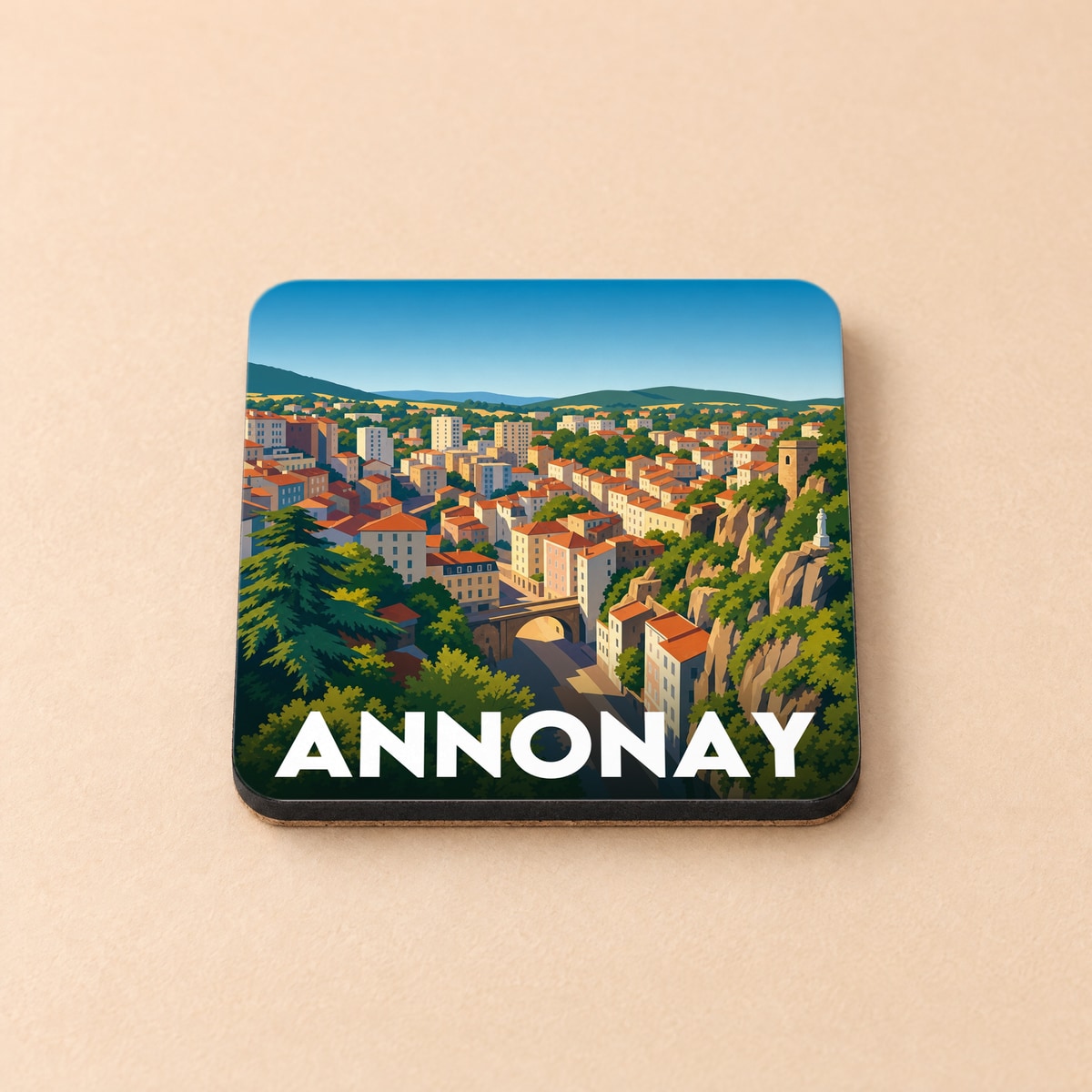 Dessous de verre souvenir de la ville d'Annonay avec une illustration stylisée et colorée.