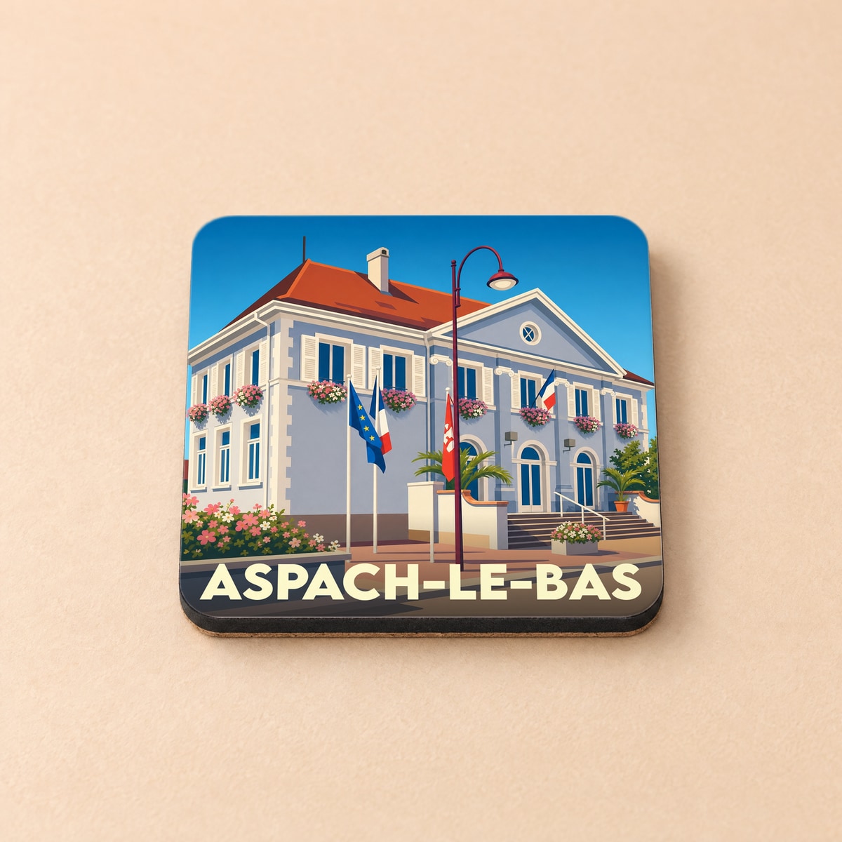 Dessous de verre souvenir de la ville de Aspach-le-Bas avec une illustration stylisée de sa mairie.