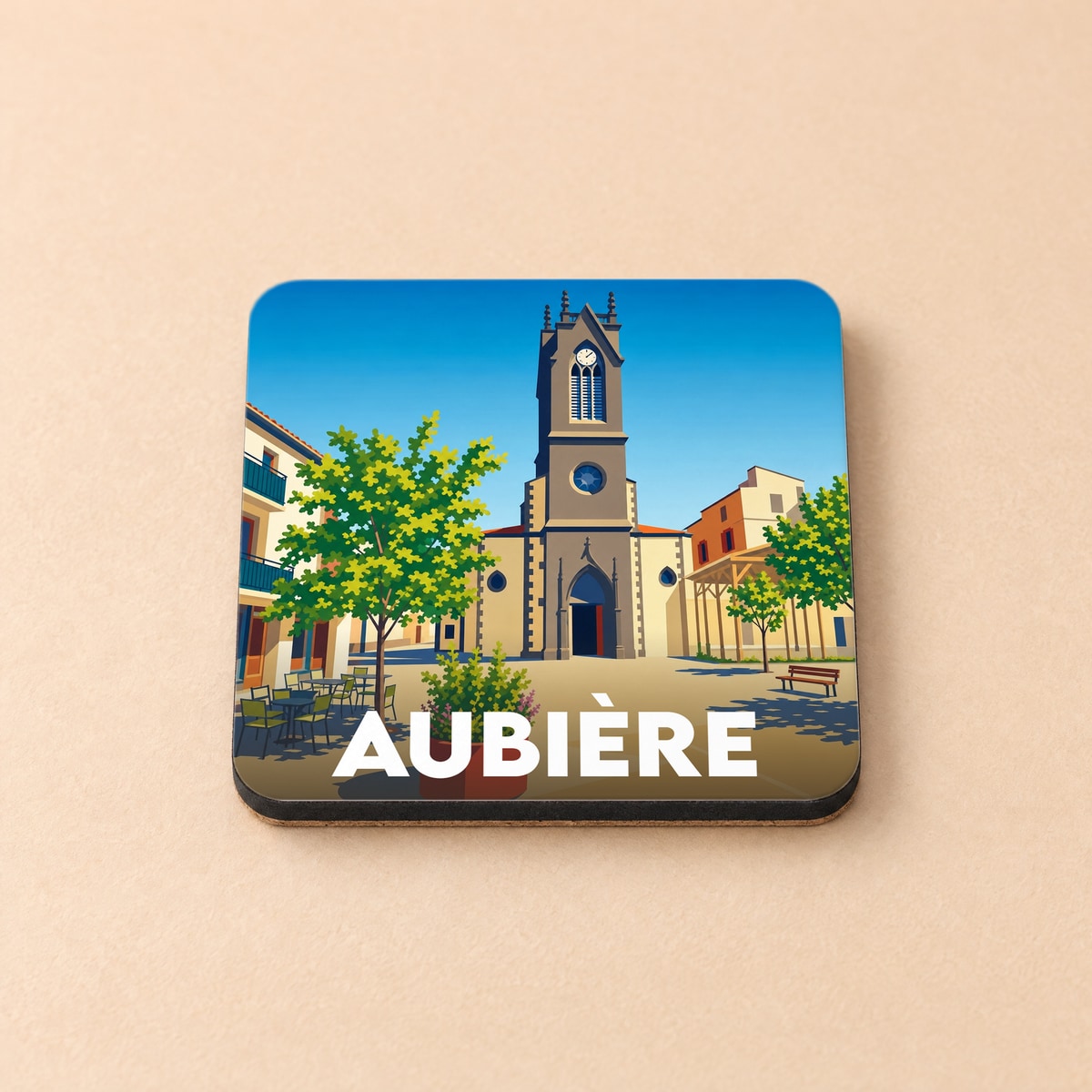 Dessous de verre souvenir de la ville d'Aubière avec une illustration stylisée de sa place centrale et de son église.
