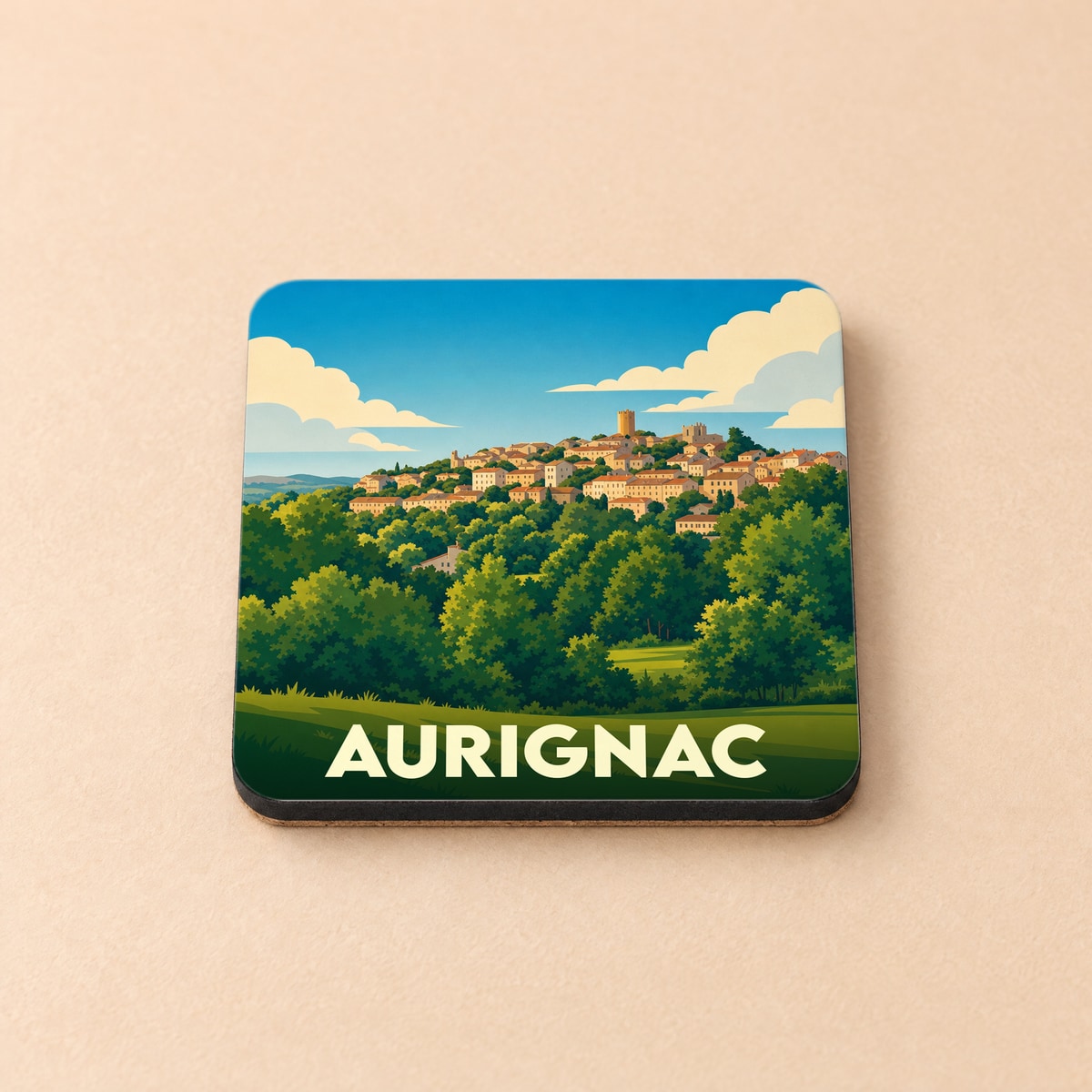 Dessous de verre souvenir de la ville d'Aurignac avec une illustration stylisée d'un village perché.