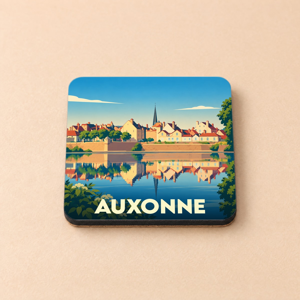 Dessous de verre souvenir de la ville de Auxonne avec une illustration stylisée d'un paysage urbain se reflétant dans l'eau.