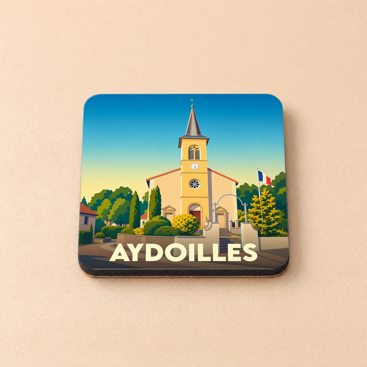 Dessous de verre souvenir de la ville d'Aydoilles avec une illustration stylisée de son église.
