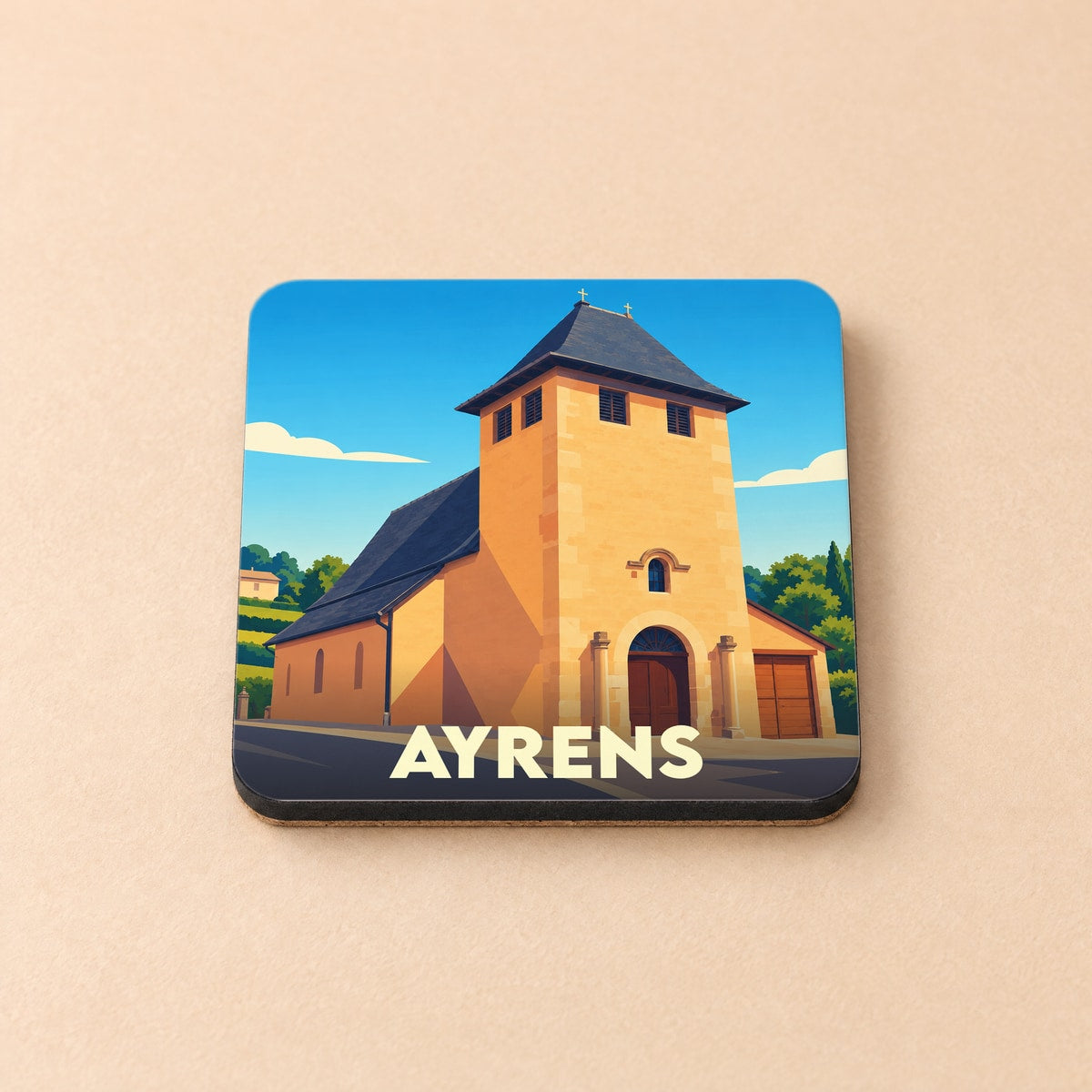 Dessous de verre souvenir de la ville d'Ayrens avec une illustration stylisée de son église.