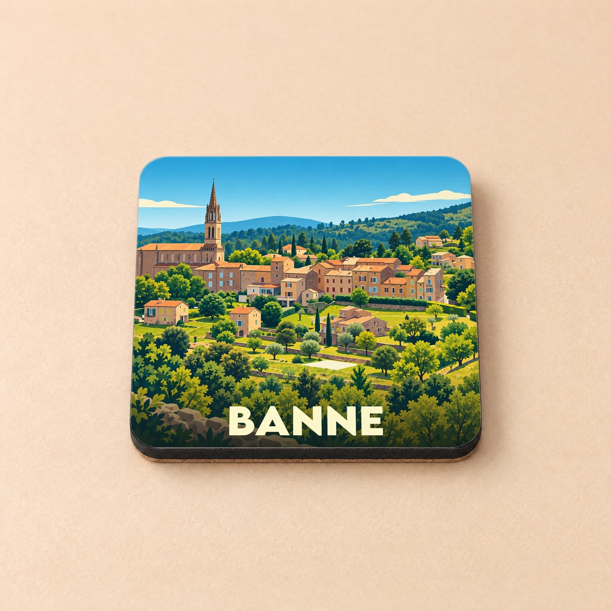 Dessous de verre souvenir de la ville de Banne avec une illustration stylisée d'un village provençal.