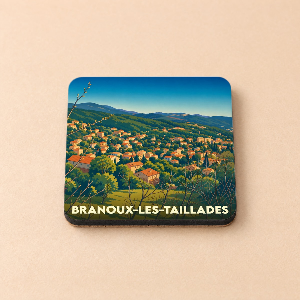 Dessous de verre souvenir de la ville de Branoux-les-Taillades avec une illustration stylisée de son paysage vallonné.