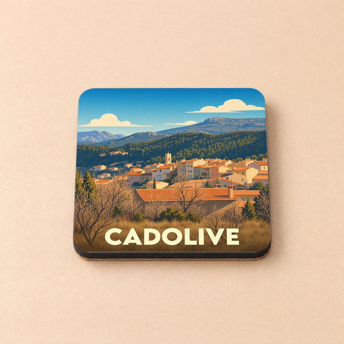 Dessous de verre souvenir de la ville de Cadolive avec une illustration stylisée d'un village provençal.