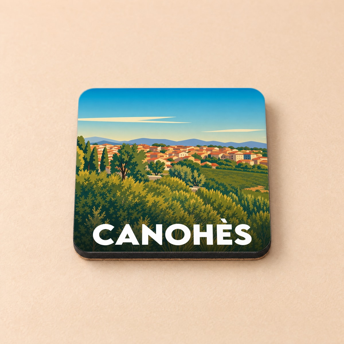 Dessous de verre souvenir de la ville de Canohès avec une illustration stylisée d'un paysage méditerranéen.