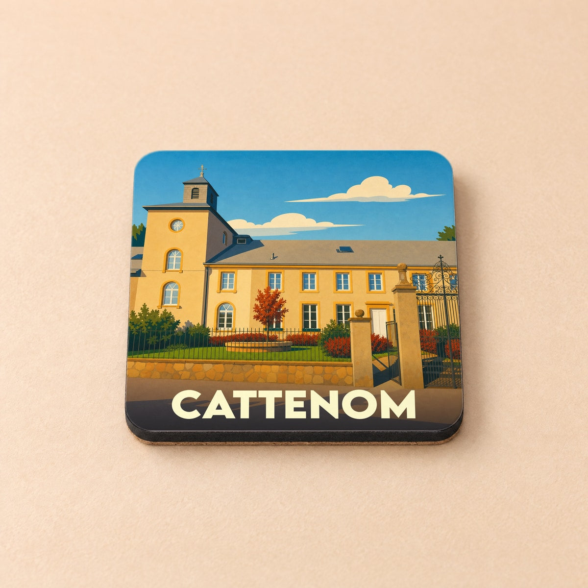 Dessous de verre souvenir de la ville de Cattenom avec une illustration stylisée d'un bâtiment historique.