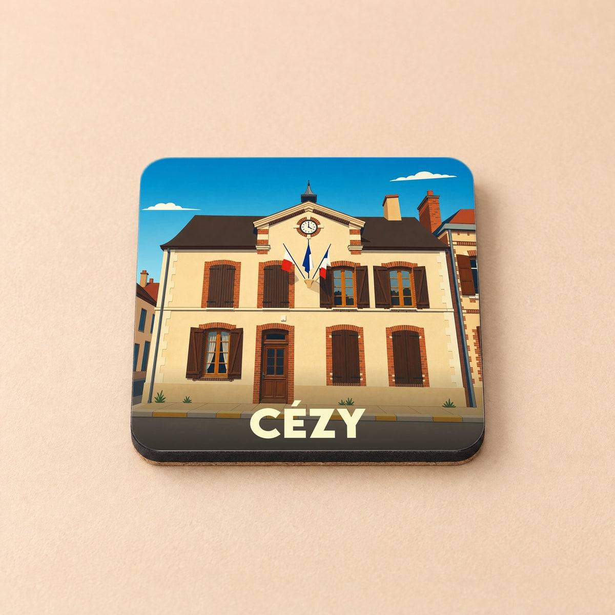 Dessous de verre souvenir de la ville de Cézy avec une illustration stylisée de sa mairie.