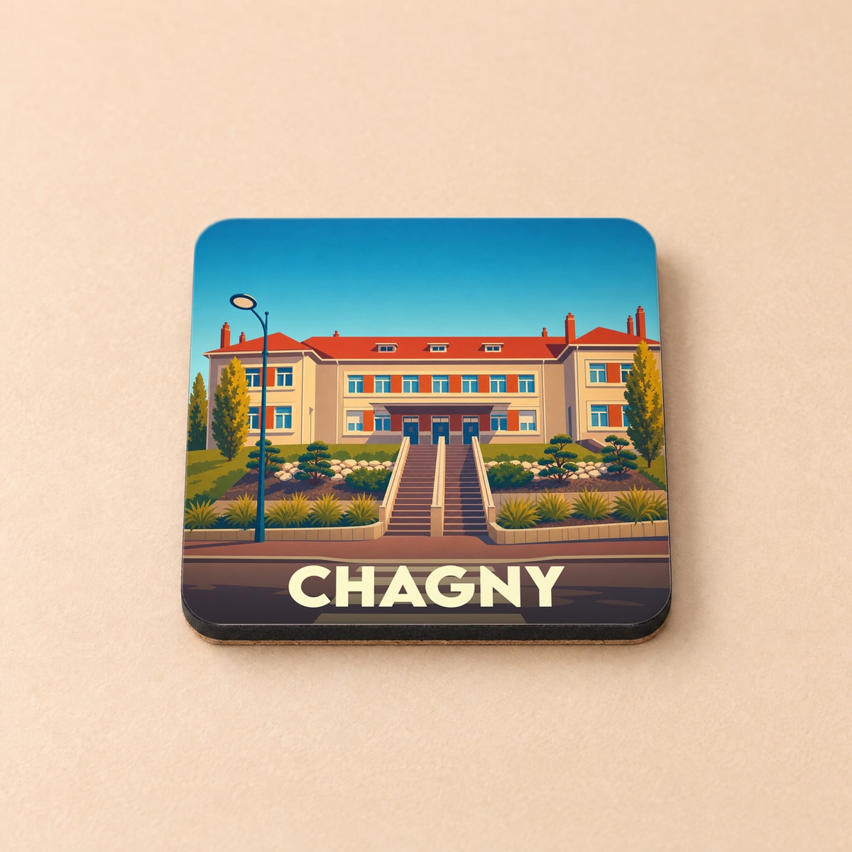 Dessous de verre souvenir de la ville de Chagny avec une illustration stylisée d'un bâtiment emblématique.
