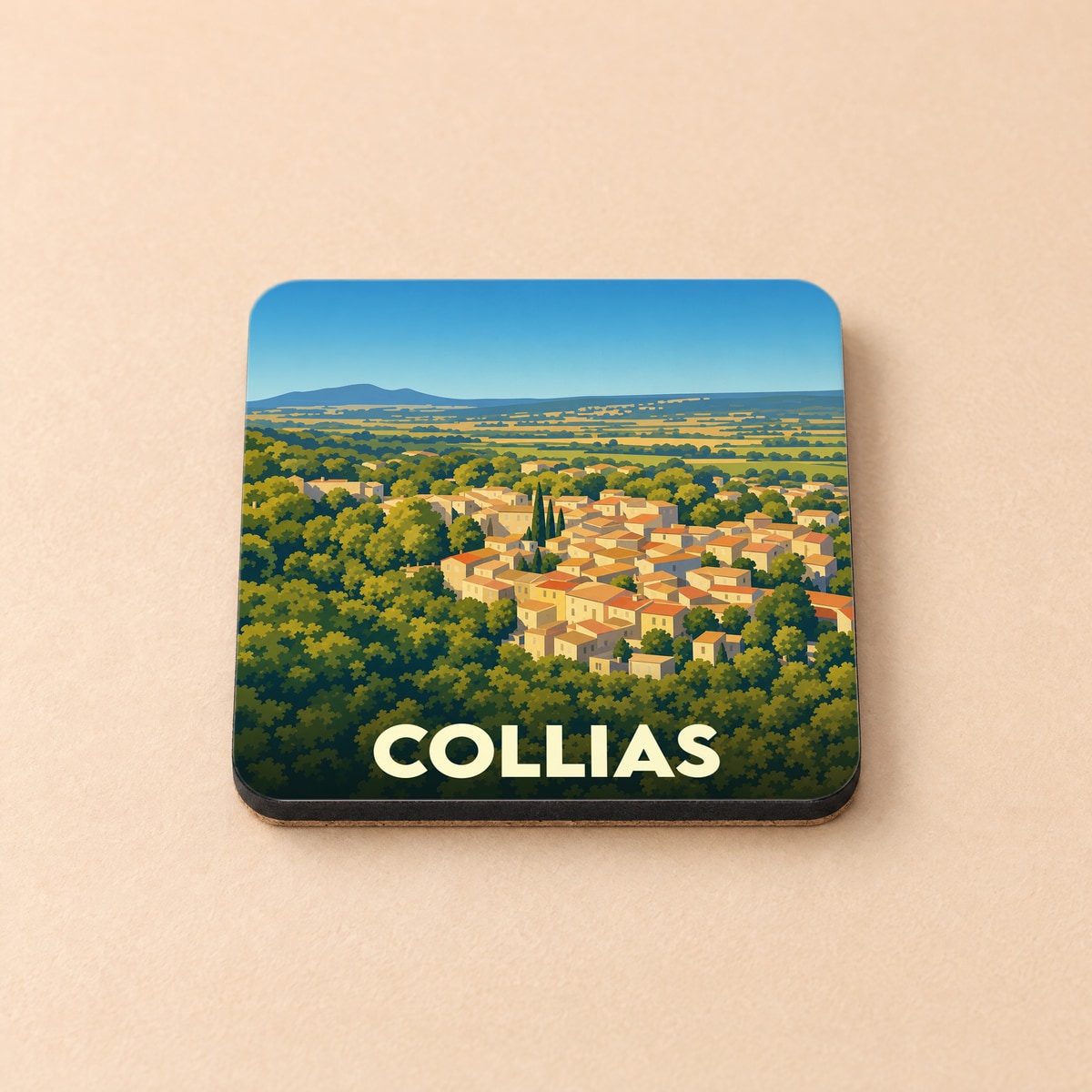 Dessous de verre souvenir de la ville de Collias avec une illustration stylisée d'un village perché.