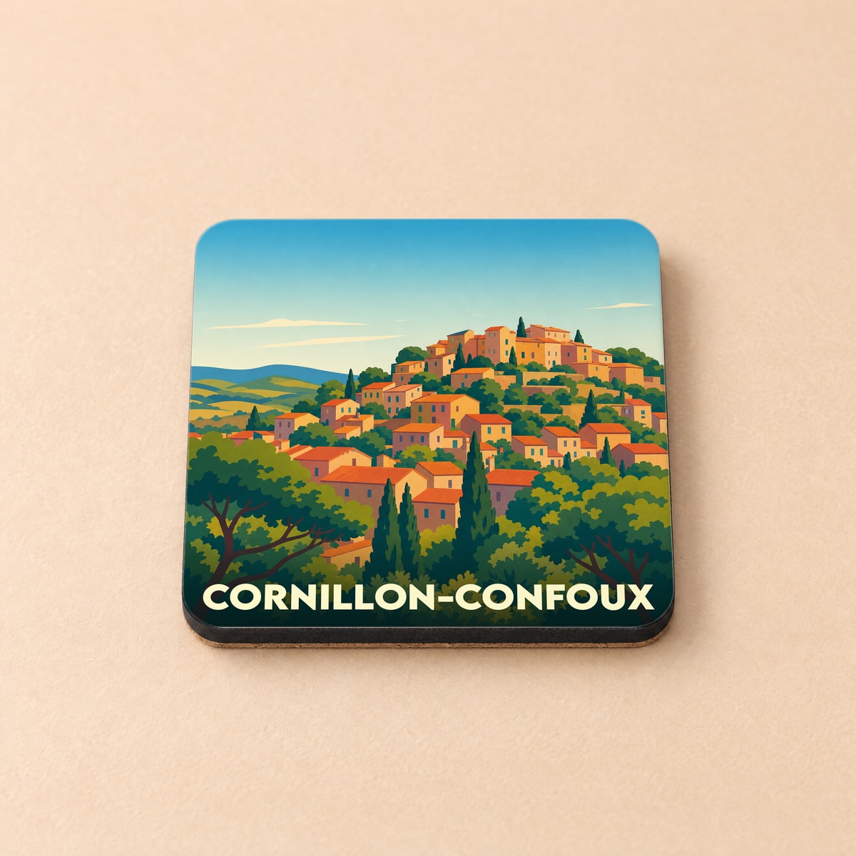 Dessous de verre souvenir de Cornillon-Confoux illustrant le village perché dans un style graphique coloré.