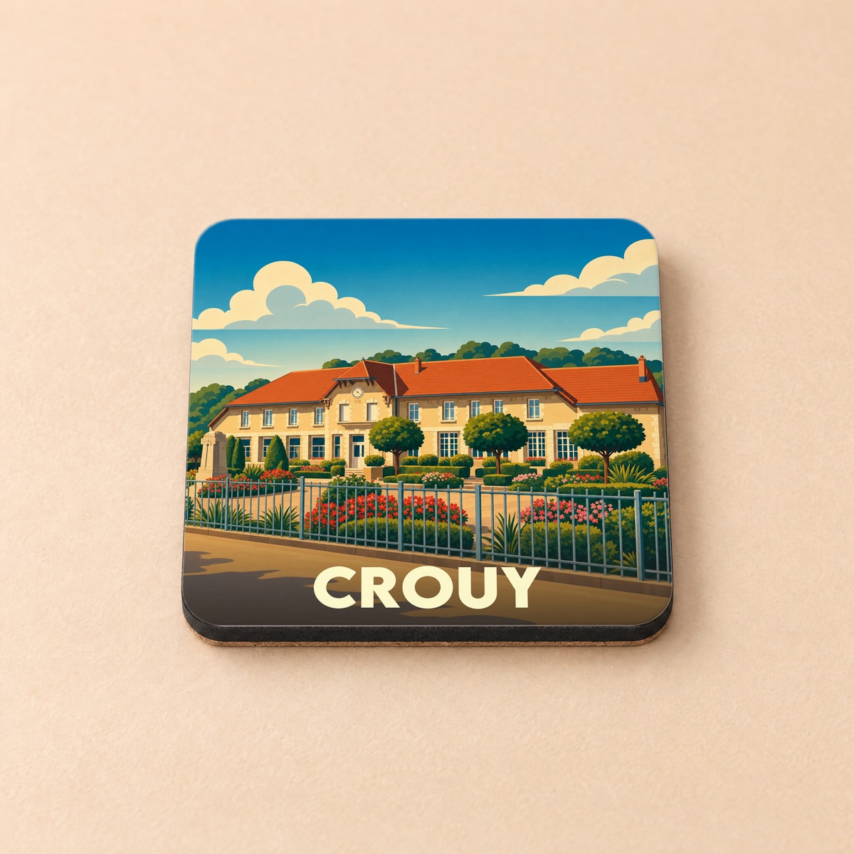 Dessous de verre souvenir de la ville de Crouy avec une illustration stylisée d'un bâtiment remarquable.