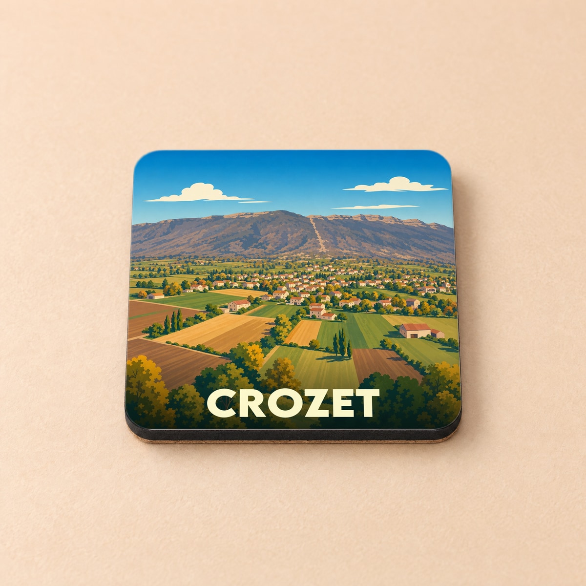 Dessous de verre souvenir de la ville de Crozet avec une illustration stylisée de son paysage montagneux et champêtre.