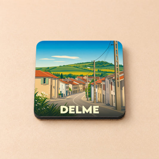 Dessous de verre souvenir de la ville de Delme avec une illustration stylisée d'un paysage de village.