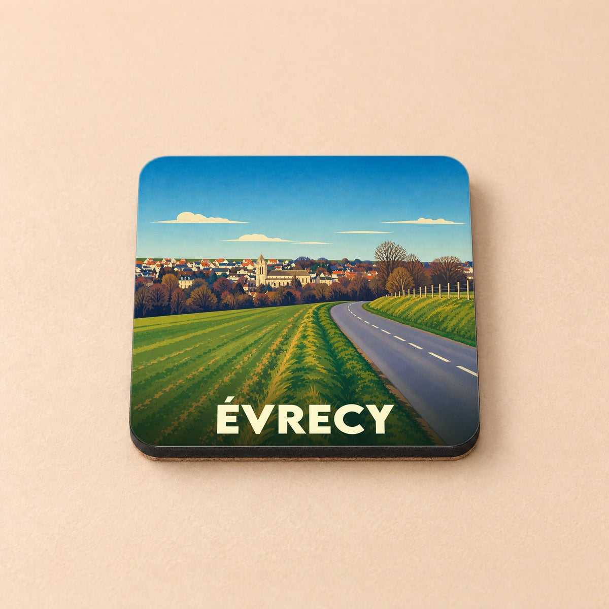 Dessous de verre souvenir de la ville d'Évrecy avec une illustration de paysage champêtre.