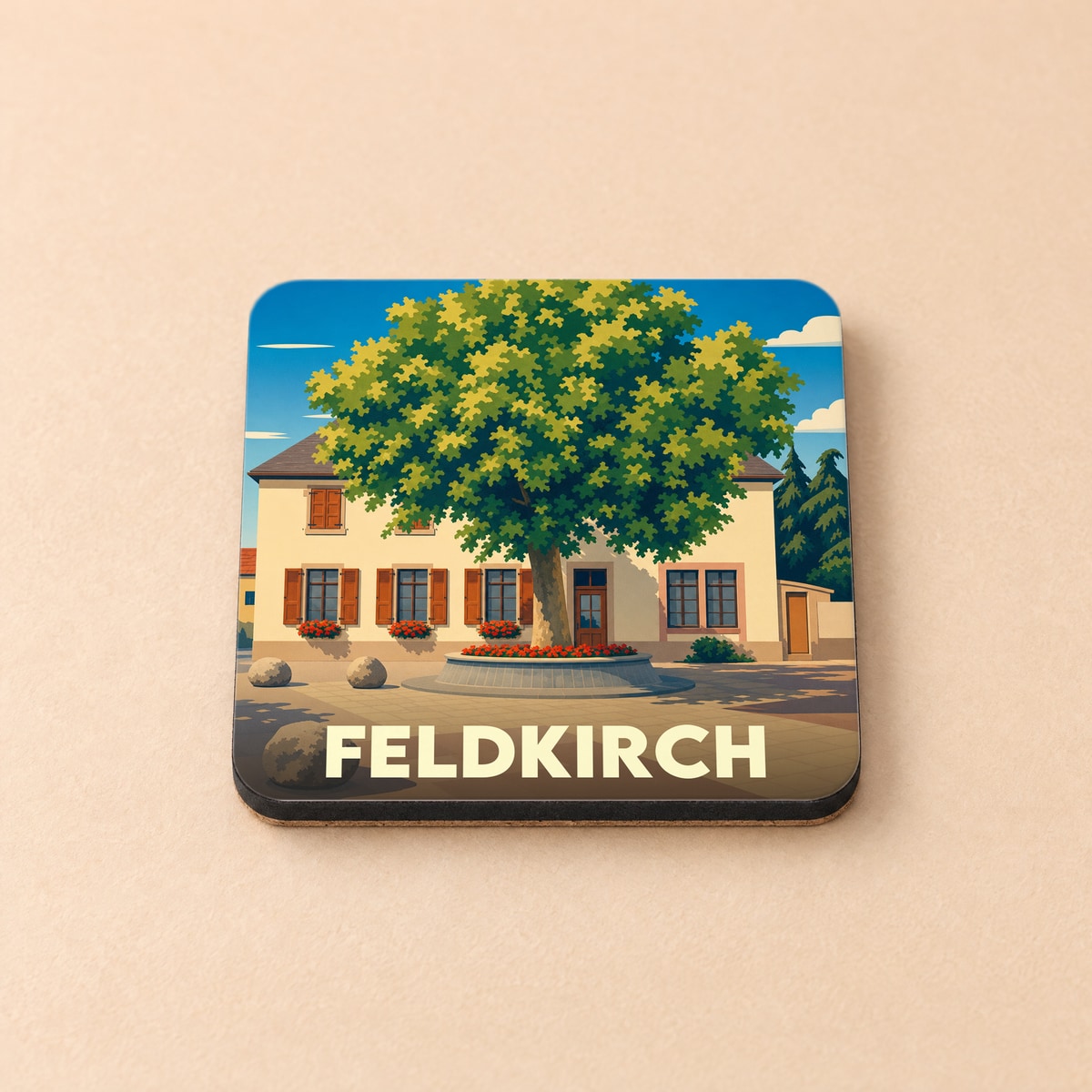Dessous de verre souvenir de la ville de Feldkirch illustré d'un grand arbre devant une maison traditionnelle.