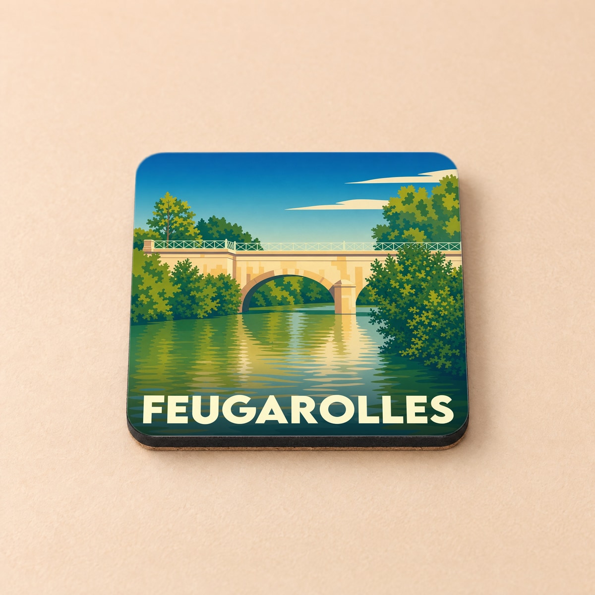 Dessous de verre souvenir de la ville de Feugarolles avec une illustration stylisée d'un pont enjambant une rivière.