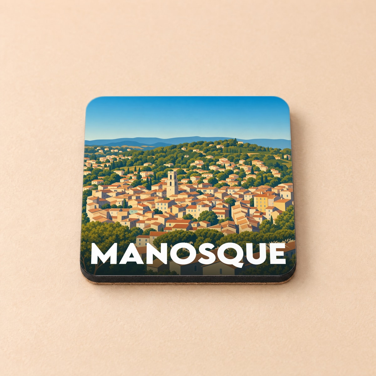 Dessous de verre souvenir de la ville de Manosque avec une illustration stylisée.