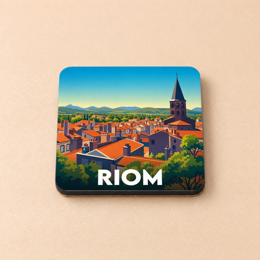 Dessous de verre souvenir de la ville de Riom avec une illustration stylisée de ses toits et de son clocher.