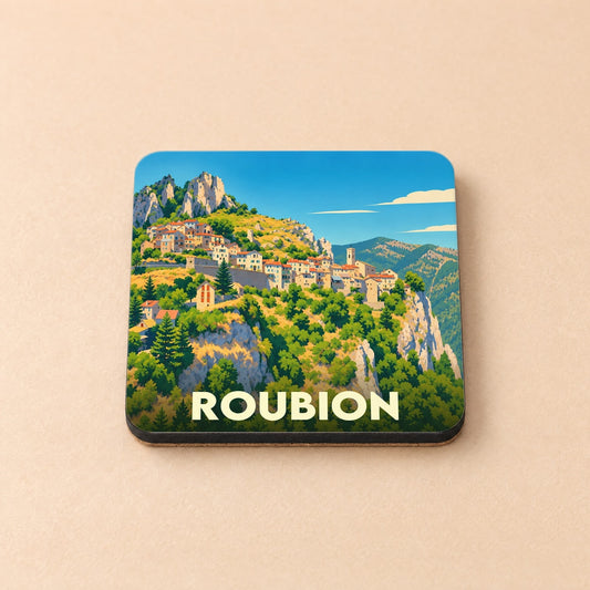 Dessous de verre souvenir de la ville de Roubion avec une illustration stylisée d'un village de montagne.