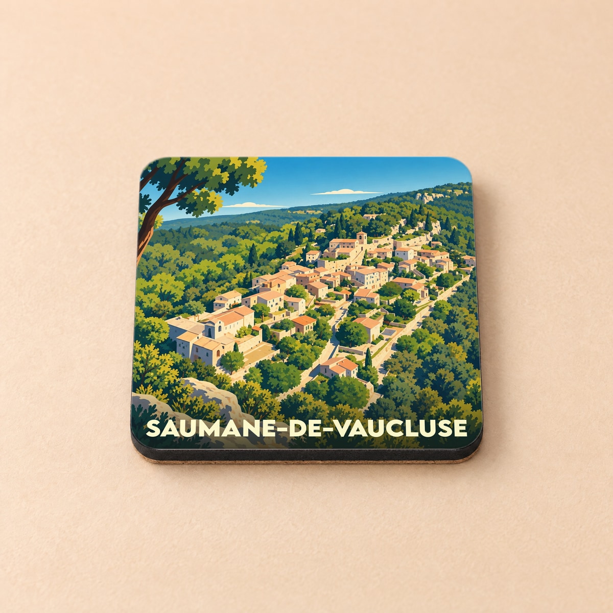 Dessous de verre souvenir de la ville de Saumane-de-Vaucluse avec une illustration stylisée d'un village perché.