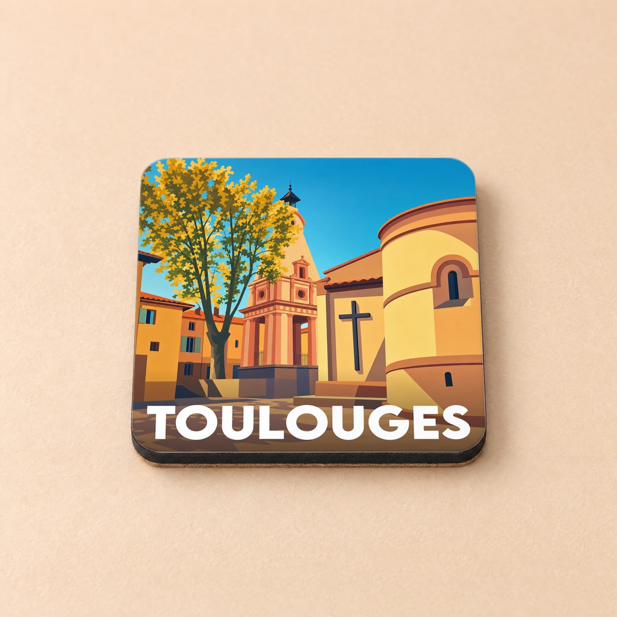 Dessous de verre souvenir de la ville de Toulouges avec une illustration stylisée et colorée de son patrimoine.