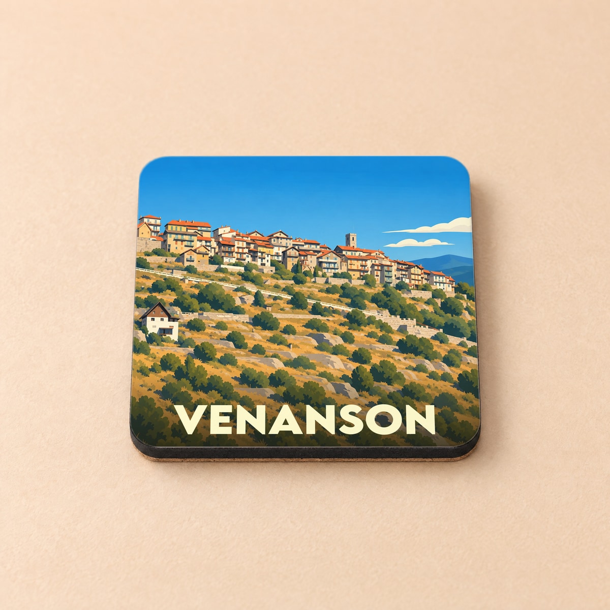 Dessous de verre souvenir de la ville de Venanson avec une illustration stylisée d'un village perché.