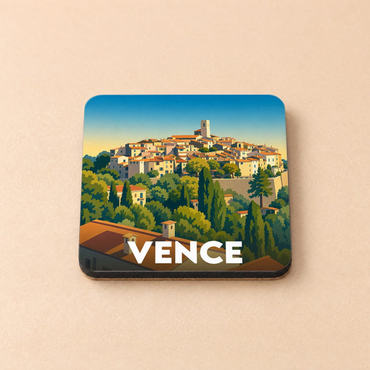 Dessous de verre souvenir de la ville de Vence avec une illustration stylisée d'un village perché.