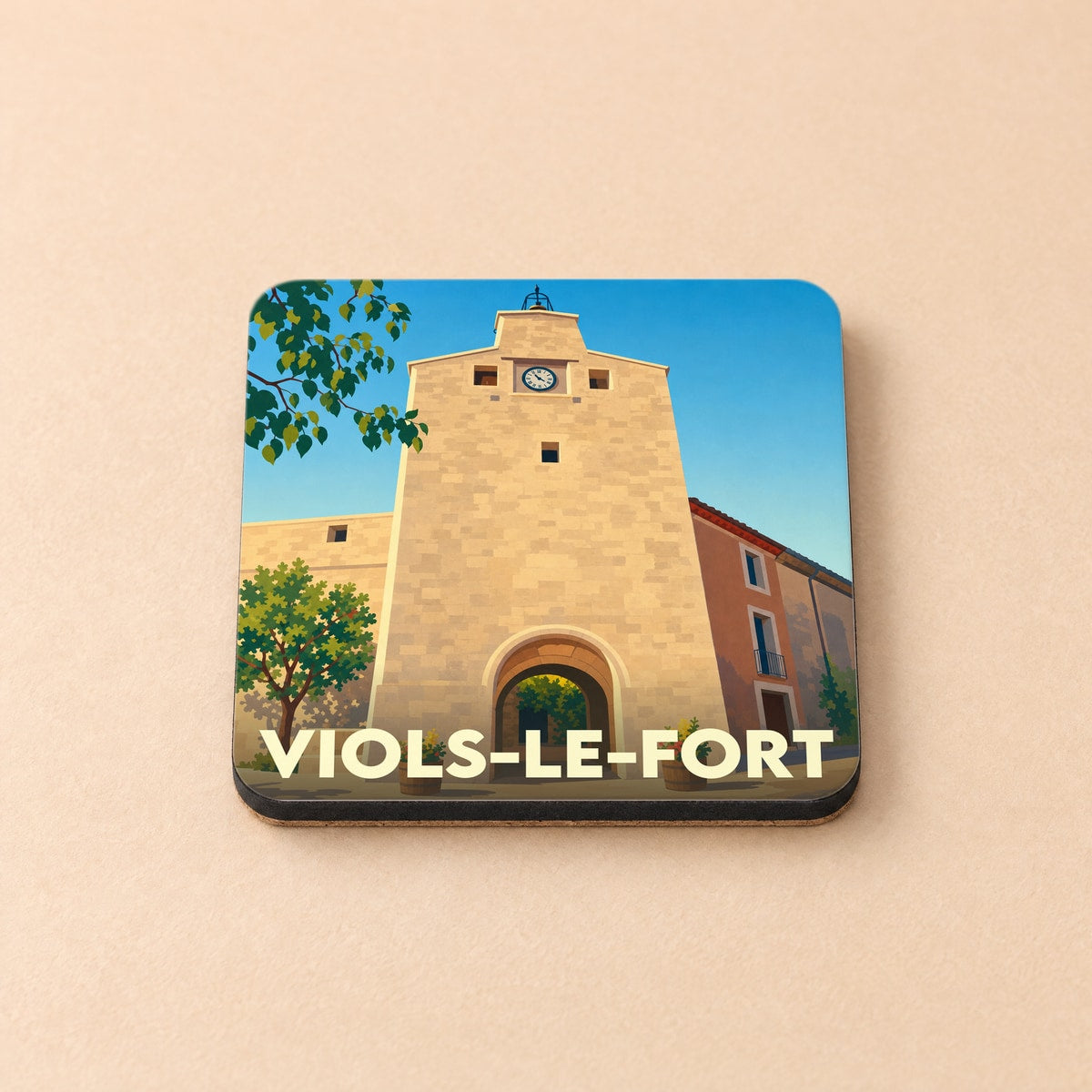 Dessous de verre souvenir de la ville de Viols-le-Fort avec une illustration stylisée de sa porte fortifiée.