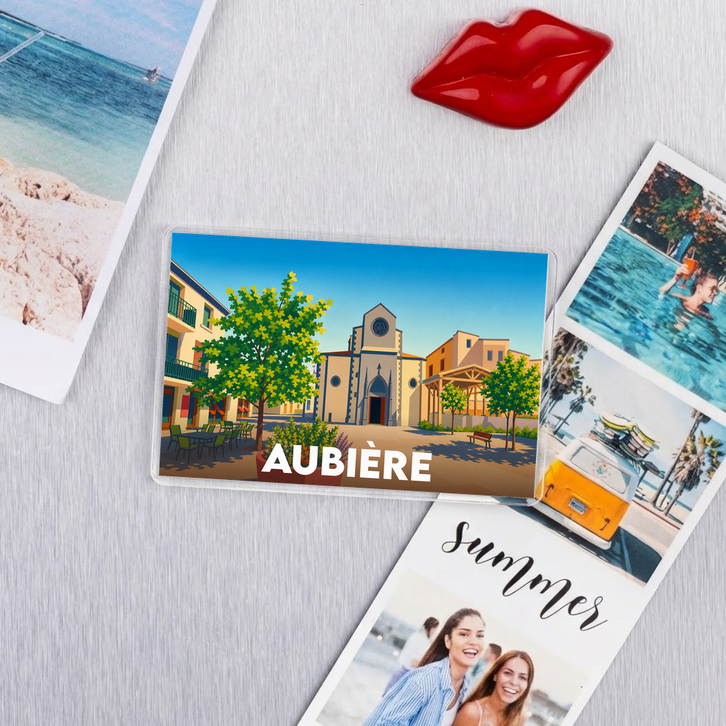 Magnet souvenir de la ville d'Aubière illustré avec une vue stylisée de sa place et de son église.