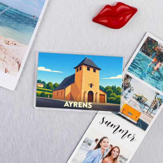 Magnet souvenir de la ville d'Ayrens avec une illustration stylisée d'une église locale.