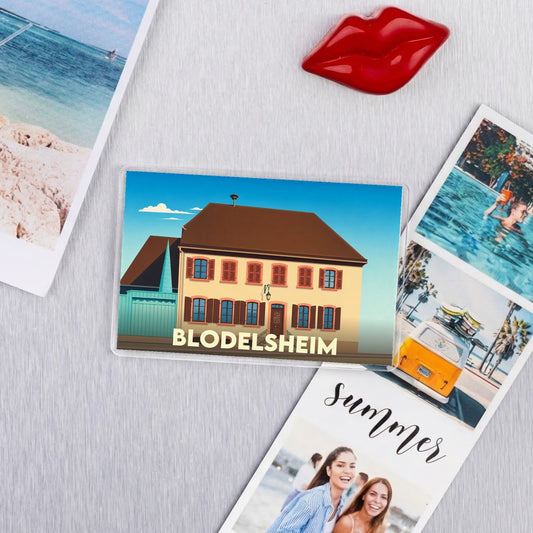 Magnet souvenir de la ville de Blodelsheim avec une illustration stylisée d'une maison traditionnelle.