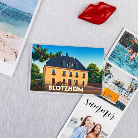 Magnet souvenir de la ville de Blotzheim avec une illustration stylisée de son architecture.