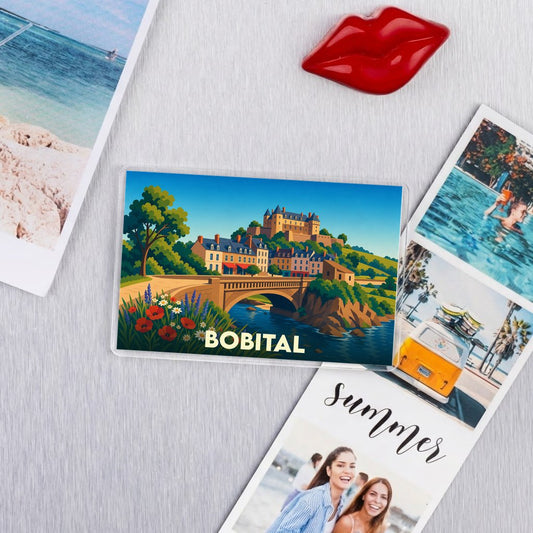 Magnet souvenir de la ville de Bobital avec une illustration stylisée d'un village médiéval et d'un pont.