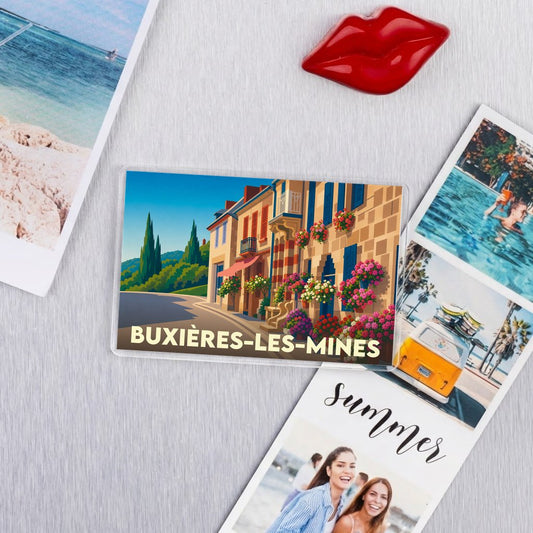 Magnet souvenir de la ville de Buxières-les-Mines avec une illustration de rue fleurie.