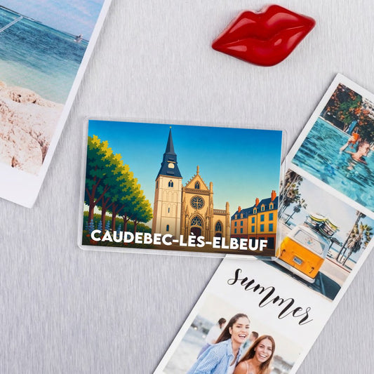 Magnet souvenir de la ville de Caudebec-lès-Elbeuf avec une illustration stylisée de son église et de ses maisons colorées.
