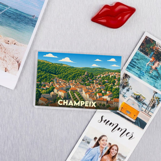 Magnet souvenir de la ville de Champeix avec une illustration stylisée de ses toits rouges et de sa vallée verdoyante.