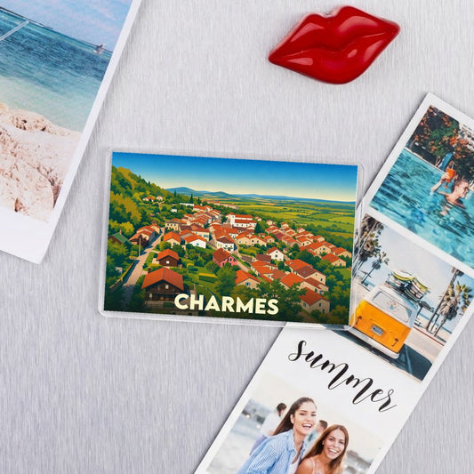 Magnet souvenir de la ville de Charmes avec une illustration stylisée d'un paysage urbain entouré de collines.