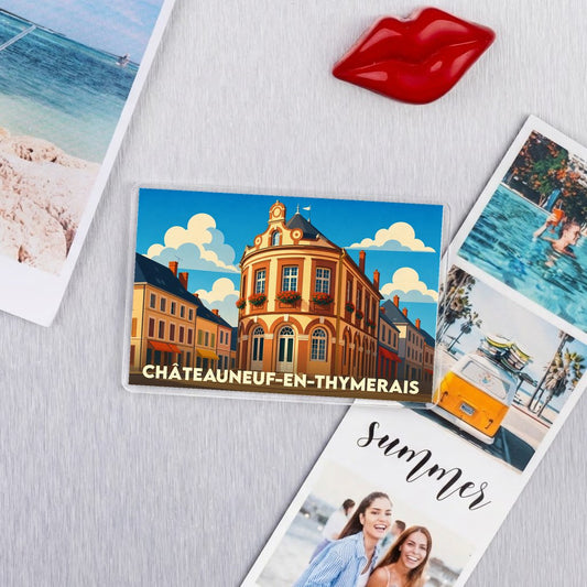 Magnet souvenir de la ville de Châteauneuf-en-Thymerais avec une illustration stylisée d'un bâtiment historique coloré.