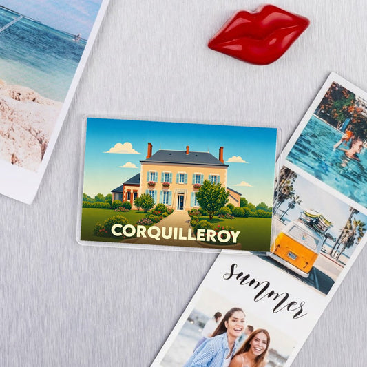 Magnet souvenir de la ville de Corquilleroy avec une illustration stylisée d'une maison de maître.