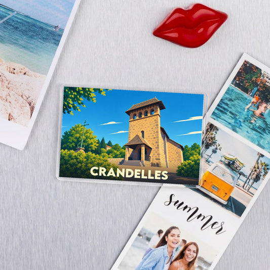Magnet souvenir de la ville de Crandelles avec une illustration stylisée de son église.