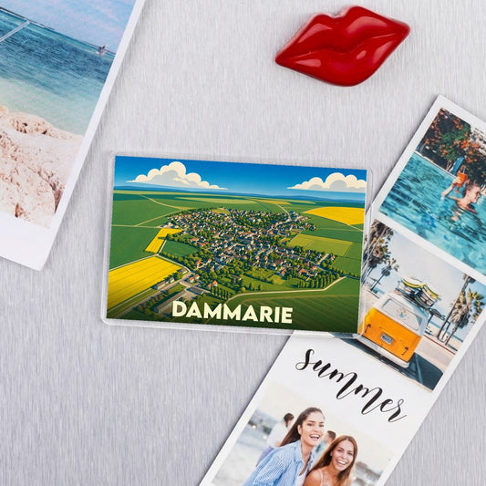 Magnet souvenir de la ville de Dammarie avec une illustration aérienne stylisée.
